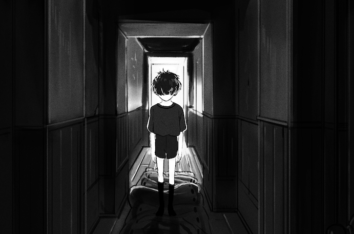 A boys stands in a dark hallway in an old house